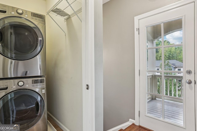 737 St Charles Ave NE, Atlanta, GA 30306 - laundry area with stacked washer / drying machine, plenty of natural light, baseboards, and wood finished floors
