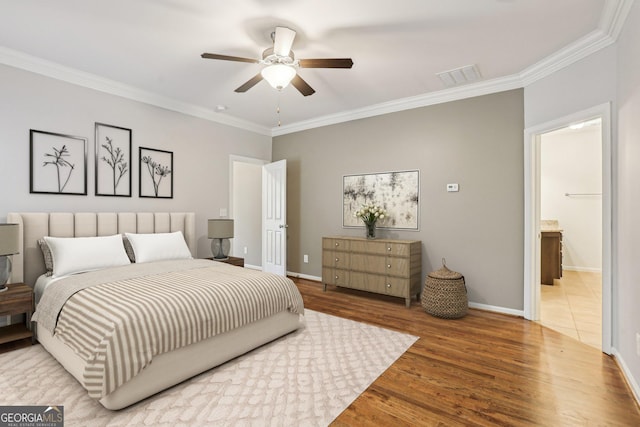 737 St Charles Ave NE, Atlanta, GA 30306 - bedroom with crown molding, wood finished floors, baseboards, ceiling fan, and connected bathroom