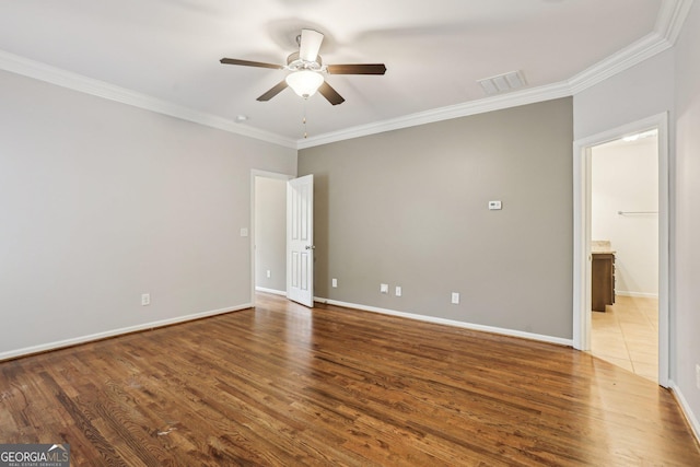 737 St Charles Ave NE, Atlanta, GA 30306 - unfurnished bedroom with ornamental molding, wood finished floors, baseboards, ceiling fan, and ensuite bathroom