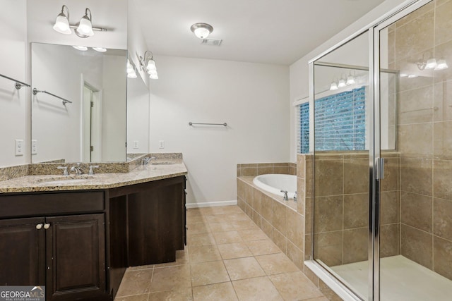 737 St Charles Ave NE, Atlanta, GA 30306 - full bath featuring tile patterned flooring, a shower stall, a garden tub, double vanity, and baseboards
