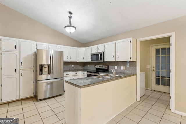 kitchen with white cabinets, light tile patterned flooring, a sink, stainless steel appliances, and tile countertops