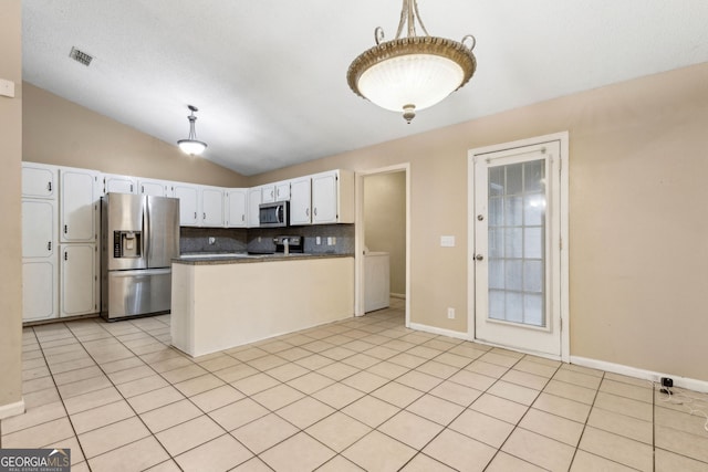 kitchen featuring stainless steel appliances, white cabinetry, lofted ceiling, backsplash, and visible vents