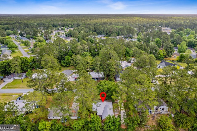 drone / aerial view featuring a residential view and a forest view