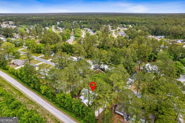 birds eye view of property with a forest view