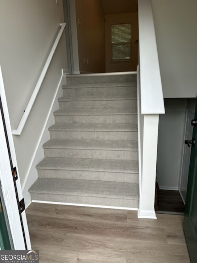 stairway featuring wood finished floors