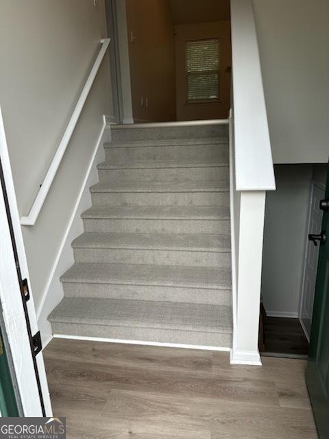 staircase featuring wood finished floors