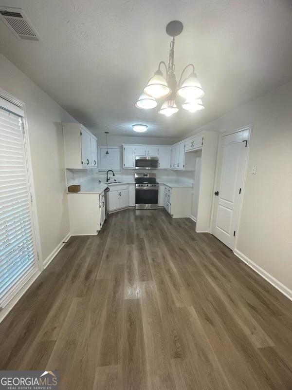 bathroom with baseboards, toilet, and wood finished floors