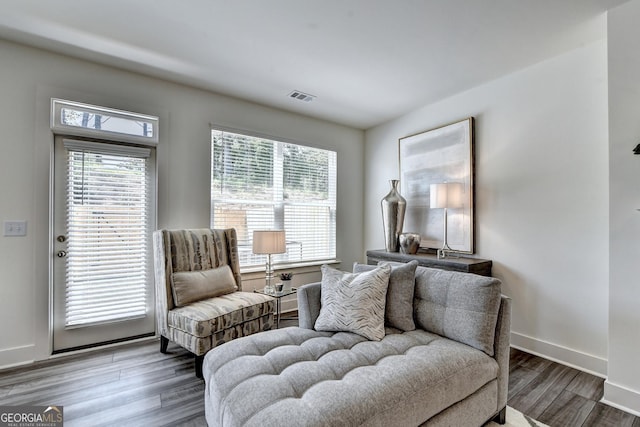 sitting room featuring baseboards, wood finished floors, and visible vents