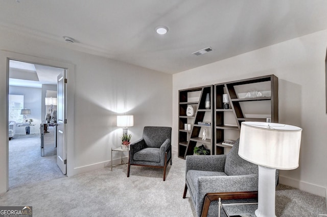 living area featuring baseboards, carpet, and visible vents