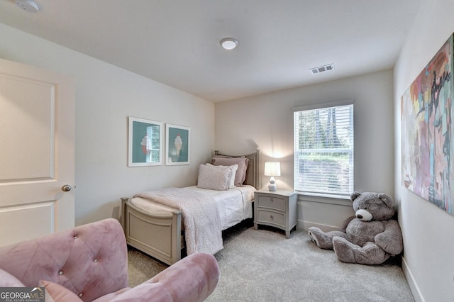 bedroom with carpet floors, baseboards, and visible vents