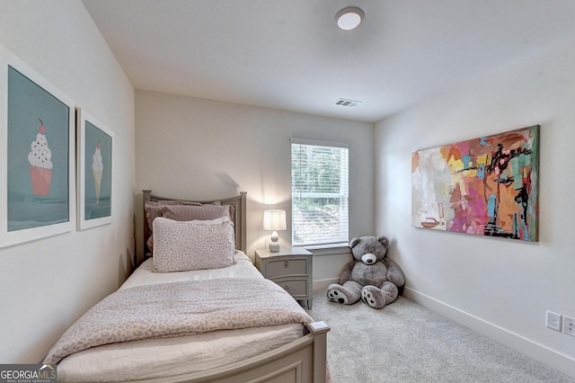 carpeted bedroom featuring baseboards and visible vents