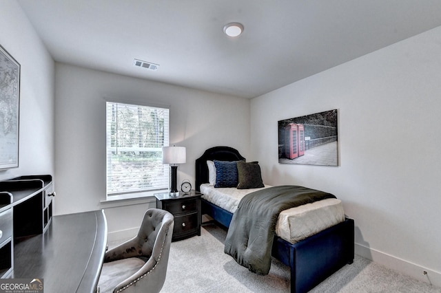 bedroom with light colored carpet, baseboards, and visible vents