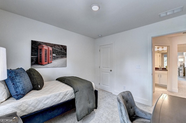 bedroom with baseboards, light colored carpet, and visible vents
