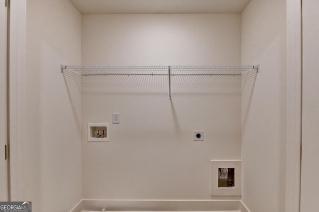 clothes washing area featuring laundry area, washer hookup, baseboards, and hookup for an electric dryer