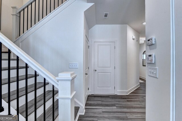 interior space with baseboards, recessed lighting, and wood finished floors