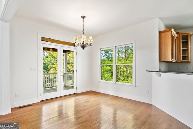 420 Martin Rd, Ellijay, GA 30536 - unfurnished dining area with a chandelier, french doors, baseboards, visible vents, and hardwood / wood-style flooring