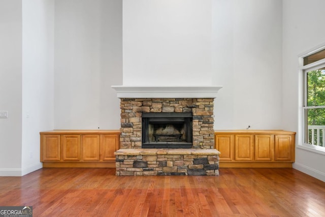 420 Martin Rd, Ellijay, GA 30536 - unfurnished living room featuring baseboards, a high ceiling, a fireplace, and wood finished floors