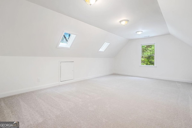 420 Martin Rd, Ellijay, GA 30536 - bonus room with baseboards, light colored carpet, and vaulted ceiling with skylight