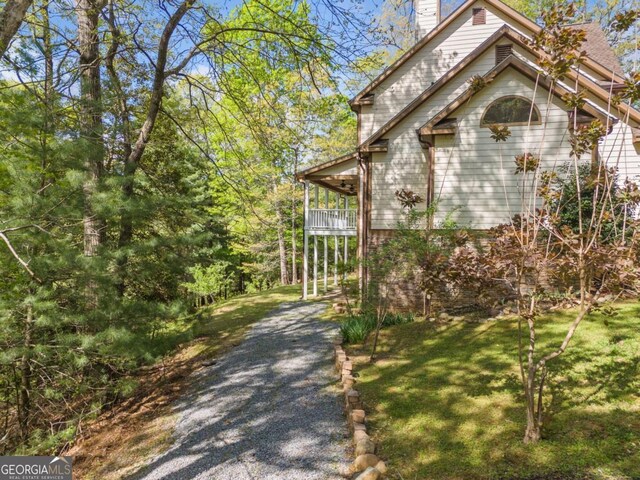 420 Martin Rd, Ellijay, GA 30536 - view of side of home with a lawn, a chimney, gravel driveway, and a balcony