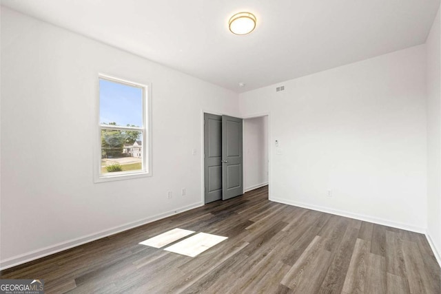 585 Ira St SW, Atlanta, GA 30312 - unfurnished bedroom with baseboards, wood finished floors, and visible vents