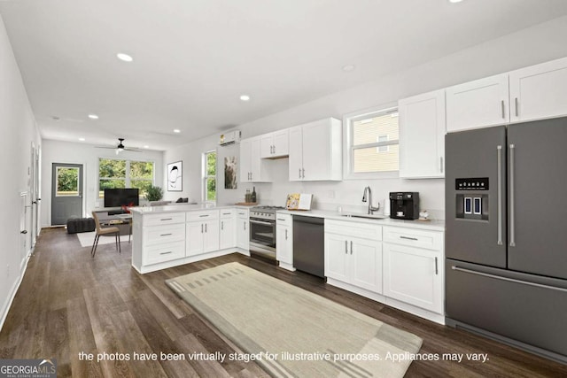 585 Ira St SW, Atlanta, GA 30312 - kitchen with a sink, a peninsula, premium appliances, recessed lighting, and white cabinetry