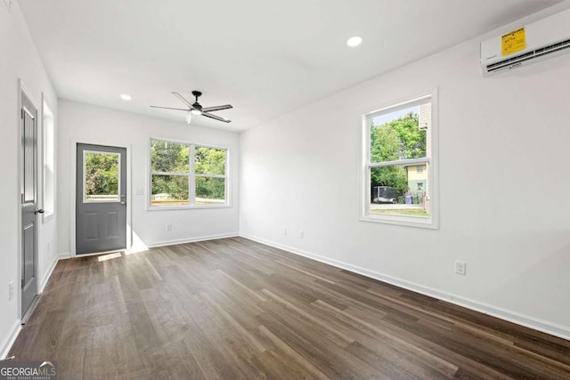 585 Ira St SW, Atlanta, GA 30312 - empty room with baseboards, ceiling fan, a wall mounted AC, and dark wood-style flooring