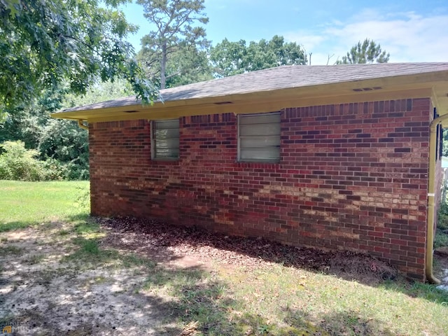 view of side of property featuring brick siding