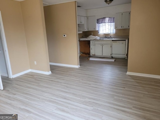 kitchen featuring baseboards, light wood-type flooring, and dishwasher