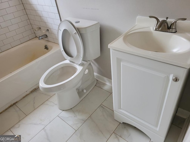 bathroom featuring baseboards, vanity, toilet, and marble finish floor