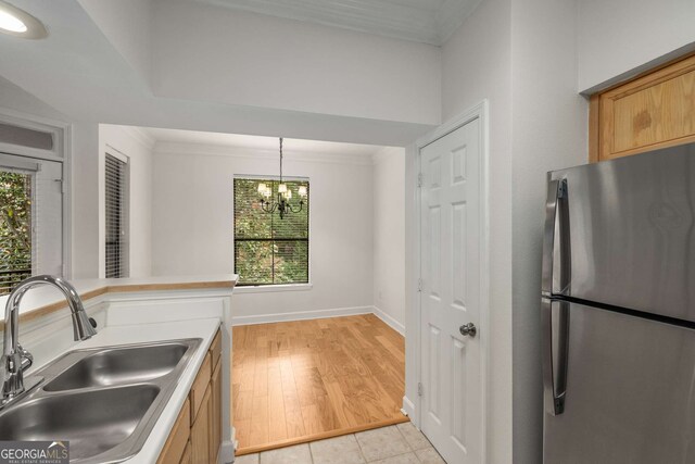 3777 Peachtree Rd Unit 1536, Atlanta, GA 30319 - kitchen with a sink, plenty of natural light, freestanding refrigerator, and an inviting chandelier