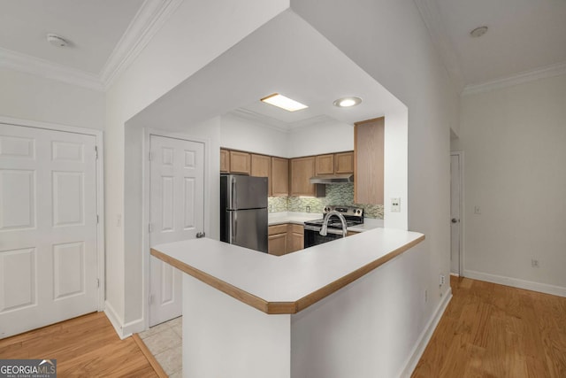 3777 Peachtree Rd Unit 1536, Atlanta, GA 30319 - kitchen with baseboards, light countertops, appliances with stainless steel finishes, and under cabinet range hood