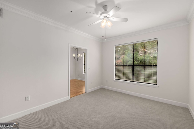 3777 Peachtree Rd Unit 1536, Atlanta, GA 30319 - spare room featuring crown molding, baseboards, light carpet, and ceiling fan with notable chandelier