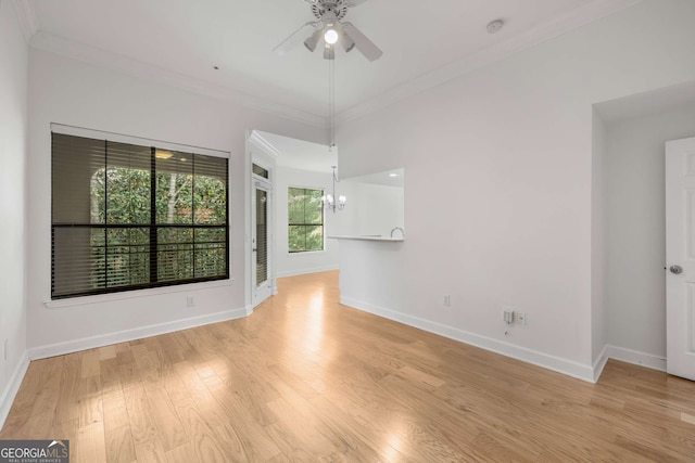 3777 Peachtree Rd Unit 1536, Atlanta, GA 30319 - spare room featuring light wood-style floors, baseboards, ornamental molding, and ceiling fan with notable chandelier