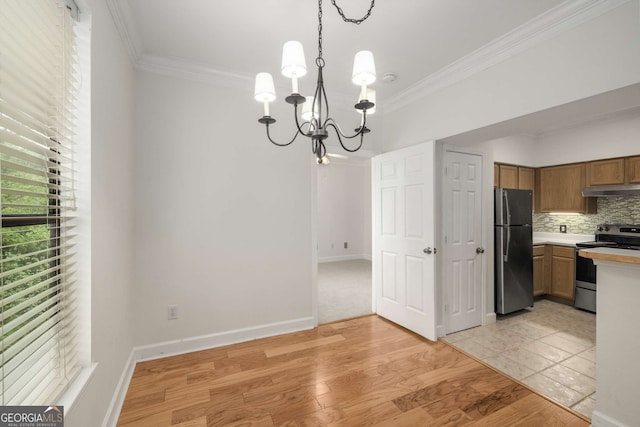 3777 Peachtree Rd Unit 1536, Atlanta, GA 30319 - unfurnished dining area with crown molding, baseboards, a notable chandelier, and light wood-type flooring