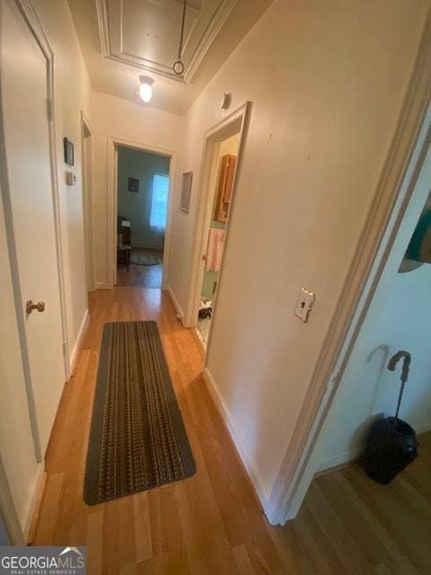 719 N 18th St, Lanett, AL 36863 - corridor featuring attic access, light wood-style floors, and baseboards
