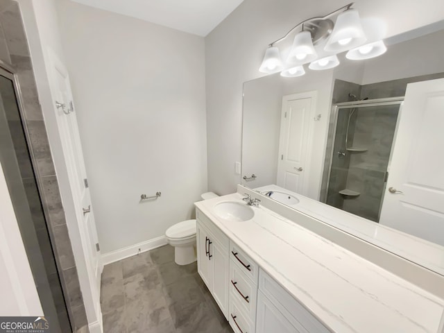 bathroom featuring vanity, baseboards, a stall shower, and toilet
