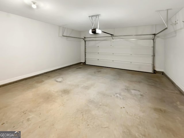garage with baseboards and a garage door opener