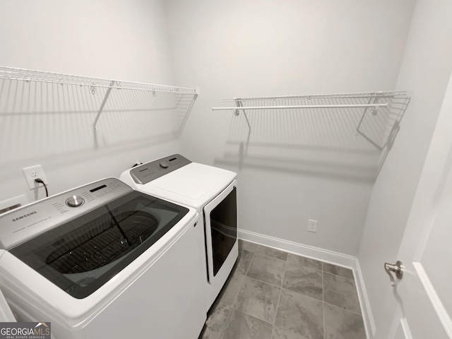 laundry room featuring baseboards, laundry area, and washer and dryer