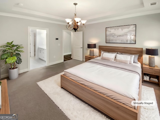 bedroom with visible vents, an inviting chandelier, baseboards, a raised ceiling, and ensuite bath