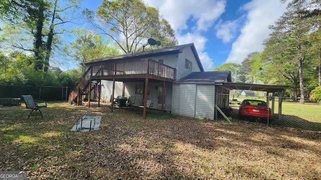 402 Emmett St, Riverdale, GA 30274 - back of property featuring stairs, fence, a wooden deck, and a carport