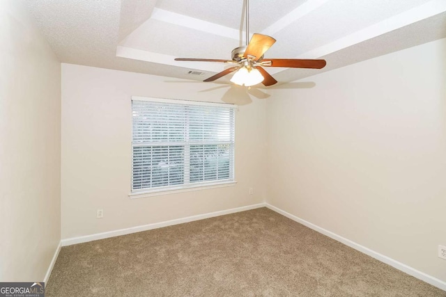 spare room with carpet flooring, a ceiling fan, and baseboards