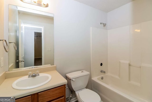 bathroom with toilet, bathing tub / shower combination, and vanity