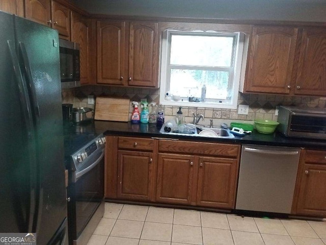 143 Delane Dr, Dallas, GA 30157 - kitchen with a sink, backsplash, dark countertops, and stainless steel appliances