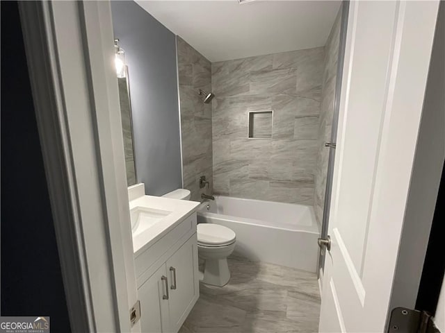 bathroom with marble finish floors, toilet, vanity, and shower / washtub combination