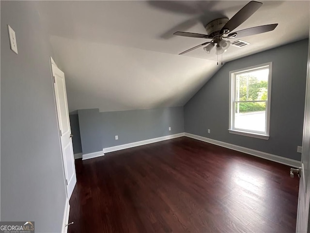 bonus room with ceiling fan, lofted ceiling, dark wood-type flooring, and baseboards