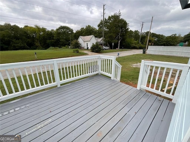 wooden deck with a lawn