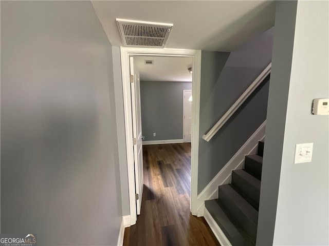 stairs featuring wood finished floors and baseboards