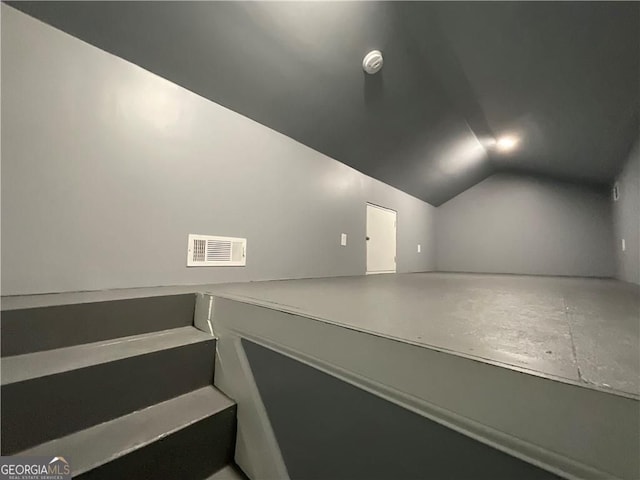 additional living space with vaulted ceiling