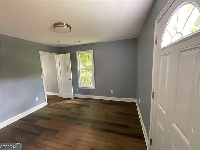 entryway with baseboards and dark wood finished floors