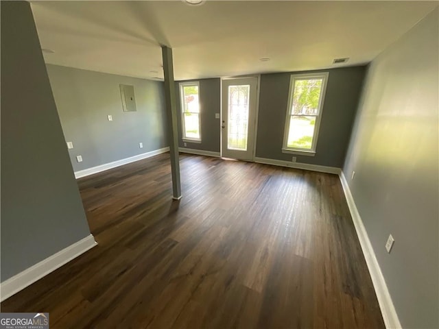 empty room featuring dark wood-style floors and healthy amount of natural light